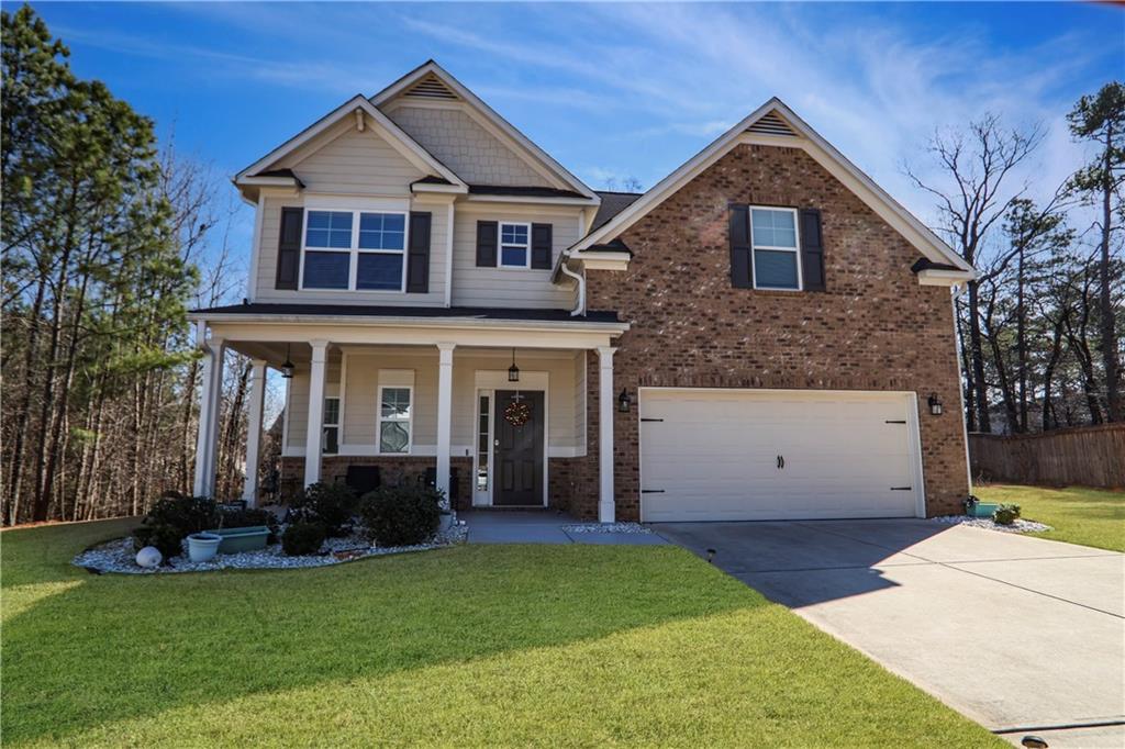 a front view of a house with a yard and garage