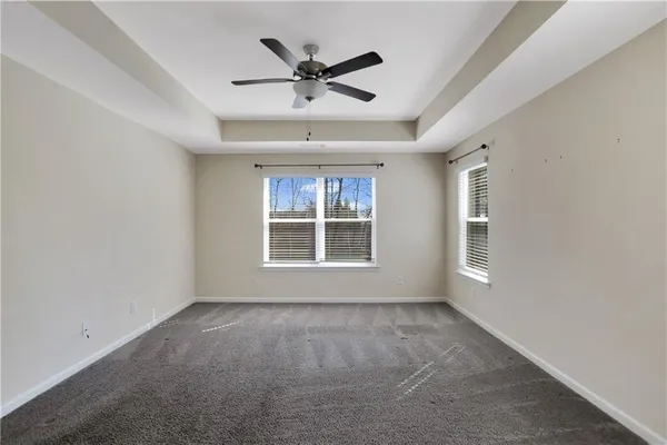 a view of a livingroom with a ceiling fan and window