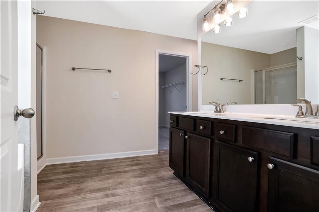7139 Southface Way Southwest Austell, GA 30168 - Photo 17 of 27 a bathroom with a double vanity sink and mirror