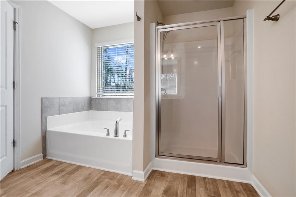 7139 Southface Way Southwest Austell, GA 30168 - Photo 18 of 27 a bathroom with a bathtub and a shower
