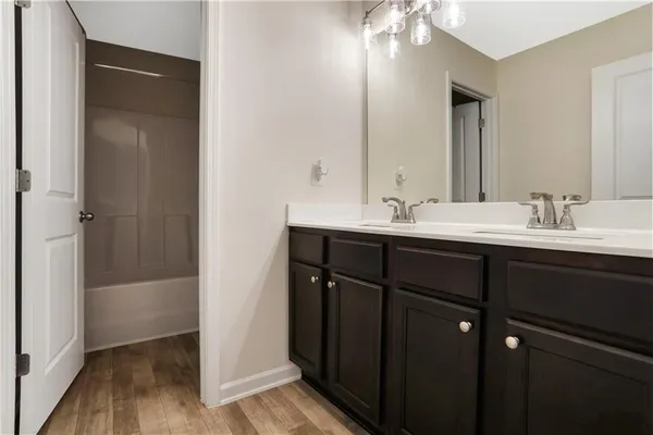 a bathroom with a double vanity sink and mirror