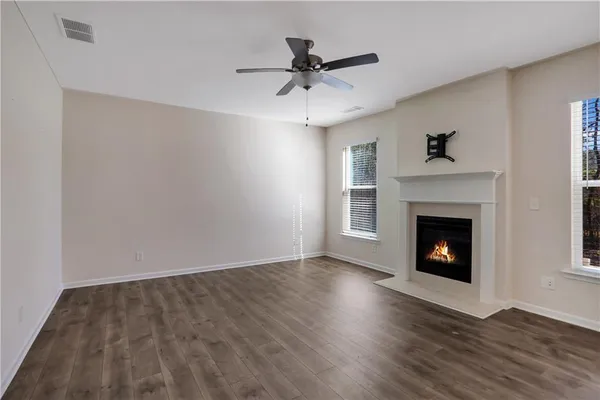 a view of a livingroom with a fireplace and wooden floor
