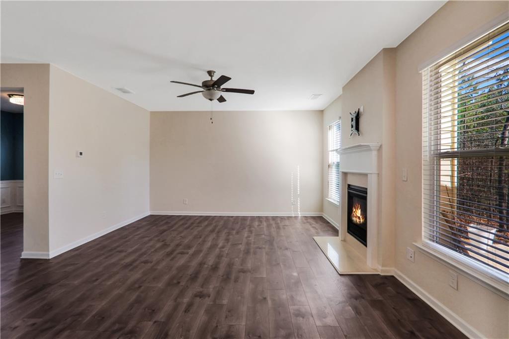 7139 Southface Way Southwest Austell, GA 30168 - Photo 7 of 27 a view of empty room with wooden floor and fireplace