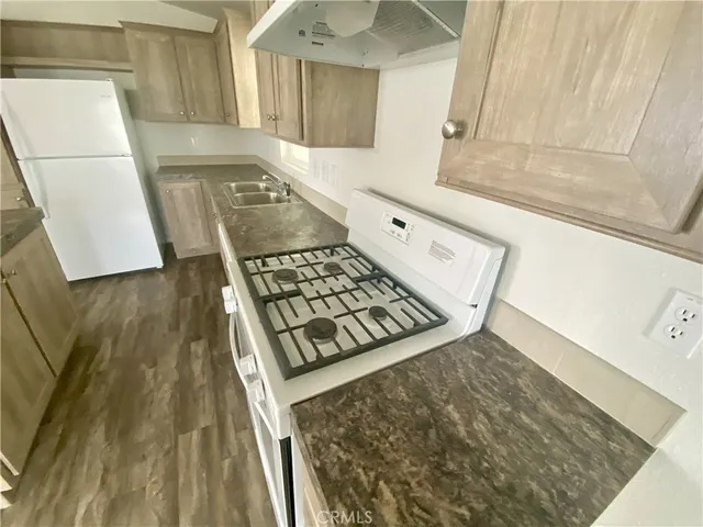 a kitchen with wooden cabinets and a stove top oven