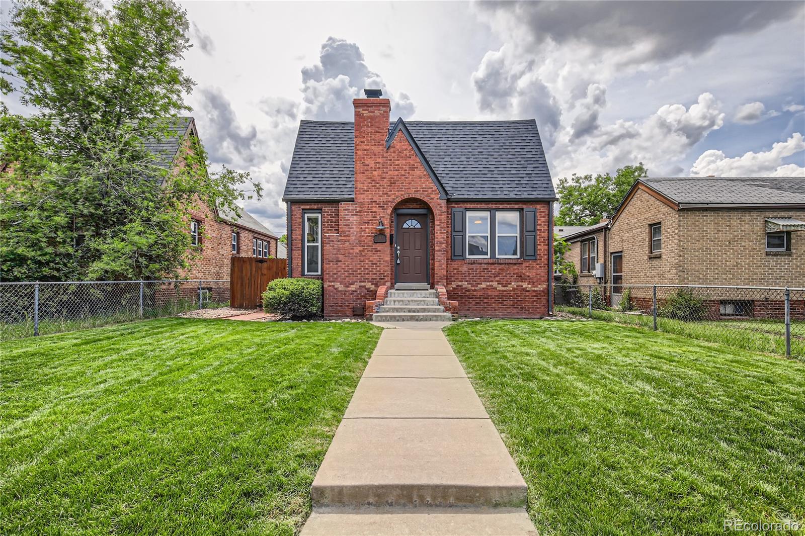 3449 Monroe Street Denver, CO 80205 - Photo 1 of 16 a front view of a house with yard
