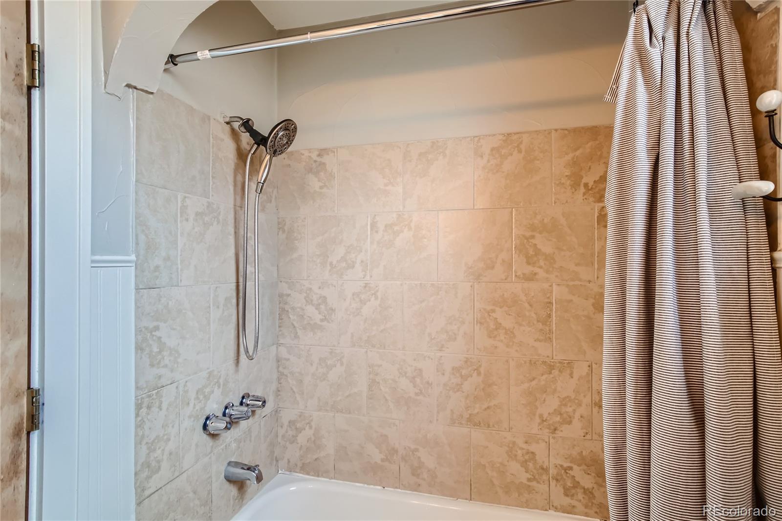 3449 Monroe Street Denver, CO 80205 - Photo 11 of 16 a bathroom with a shower