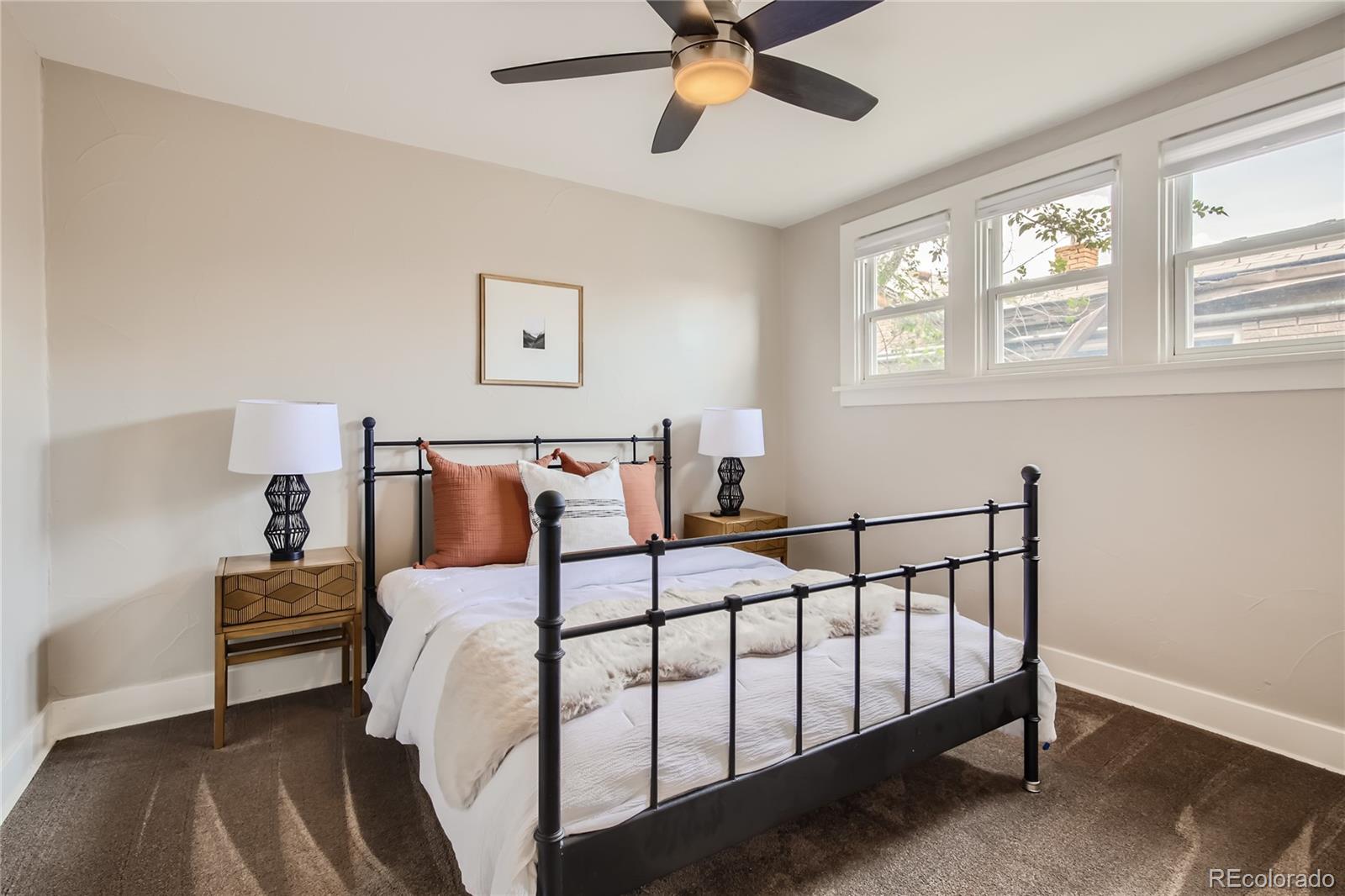 3449 Monroe Street Denver, CO 80205 - Photo 12 of 16 a bedroom with a bed and a window