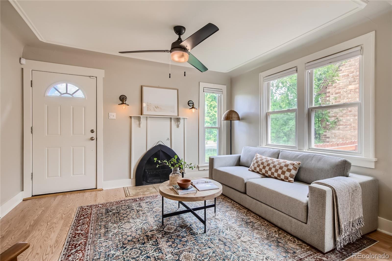 3449 Monroe Street Denver, CO 80205 - Photo 2 of 16 a living room with furniture a large window and a rug