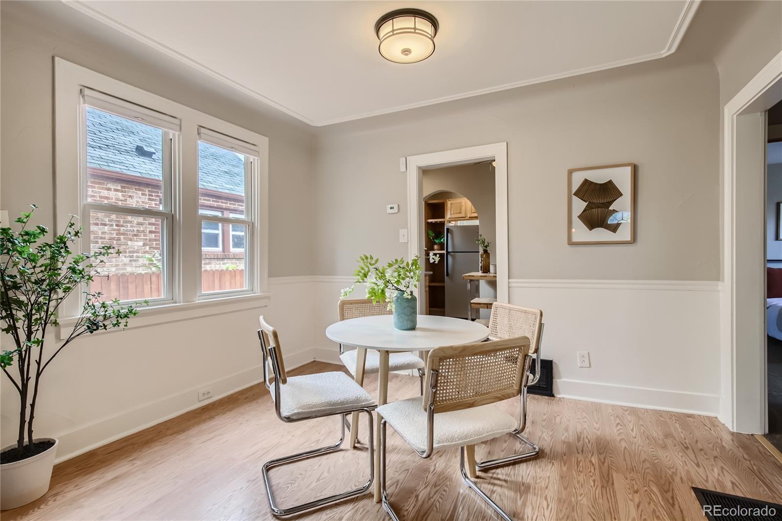 3449 Monroe Street Denver, CO 80205 - Photo 4 of 16 a view of a dining room with furniture and window