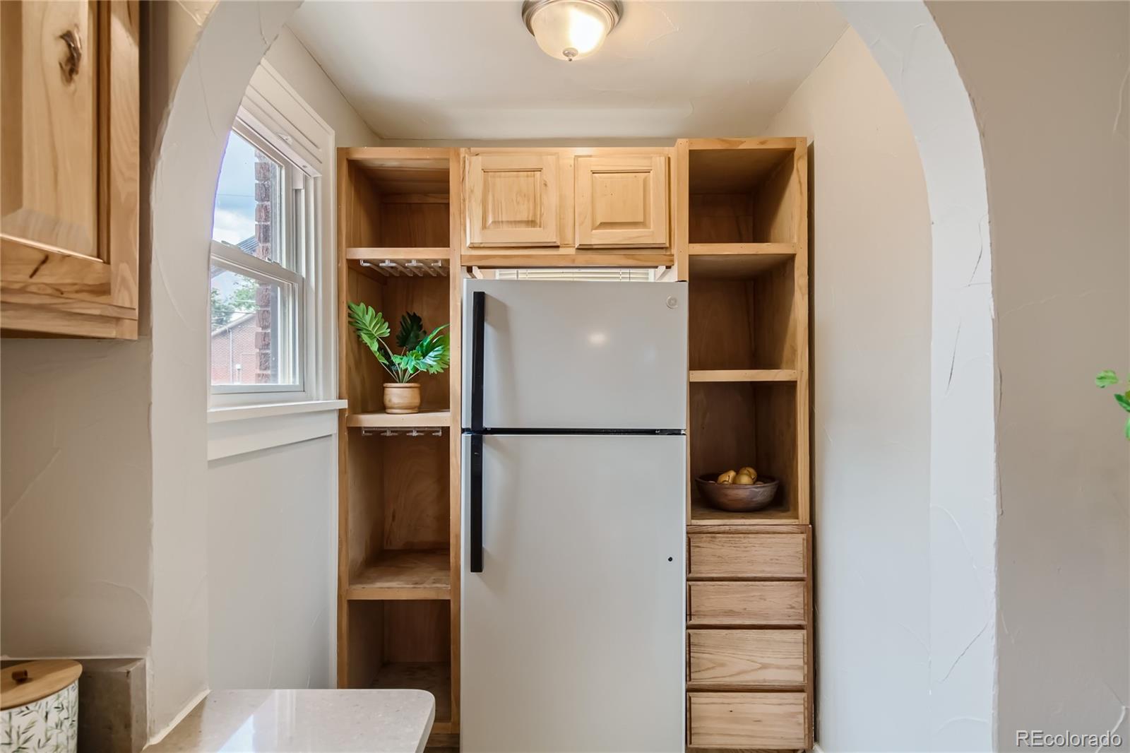 3449 Monroe Street Denver, CO 80205 - Photo 6 of 16 a view of kitchen with furniture and refrigerator