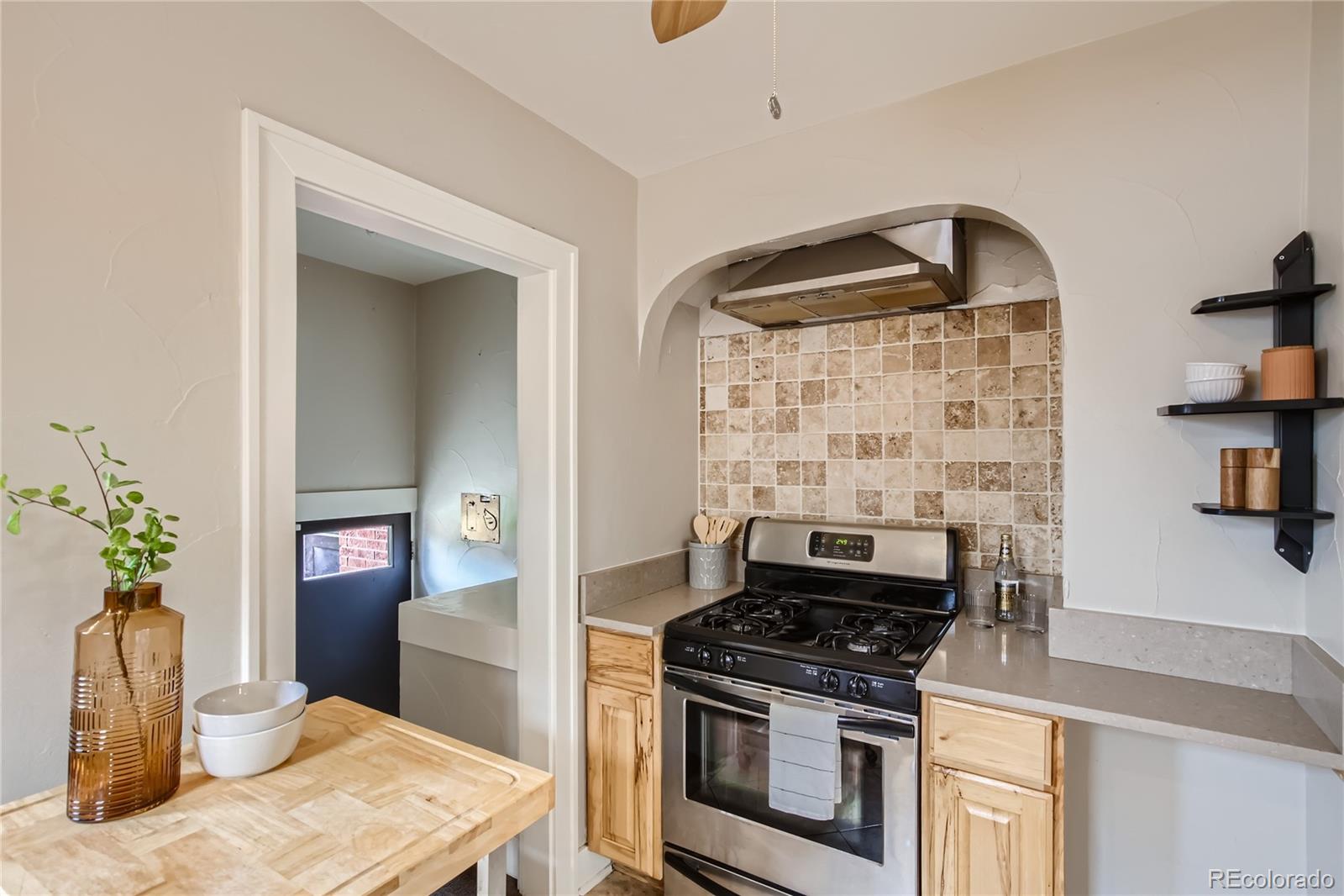 3449 Monroe Street Denver, CO 80205 - Photo 7 of 16 a kitchen with a stove and a wooden floors