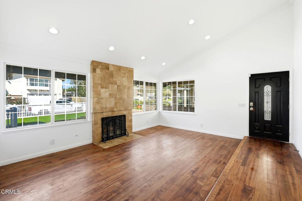 2082 Belgrave Court Simi Valley, CA 93063 - Photo 15 of 56 an empty room with wooden floor fireplace and windows