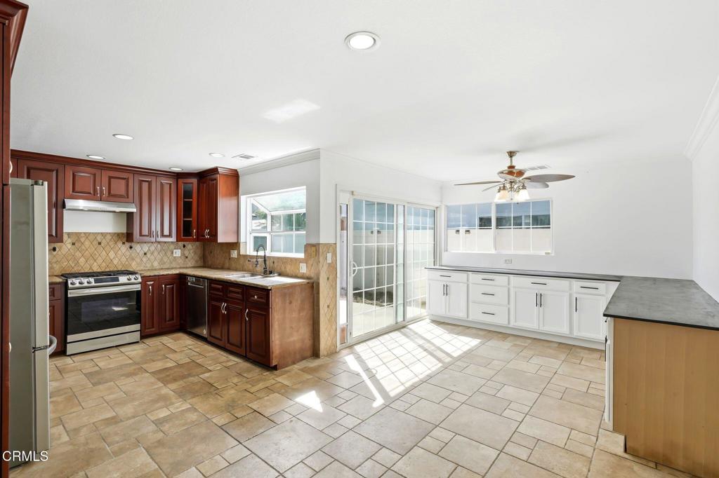 2082 Belgrave Court Simi Valley, CA 93063 - Photo 19 of 56 a large kitchen with kitchen island granite countertop a large counter top cabinets and stainless steel appliances
