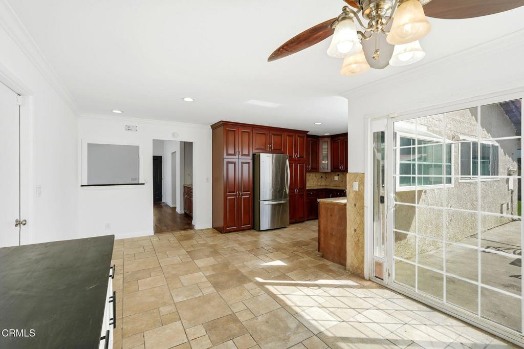 2082 Belgrave Court Simi Valley, CA 93063 - Photo 22 of 56 a large kitchen with stainless steel appliances kitchen island granite countertop a refrigerator and a sink
