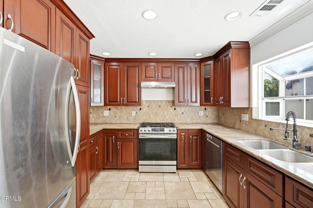 2082 Belgrave Court Simi Valley, CA 93063 - Photo 23 of 56 a kitchen with a sink stove and refrigerator