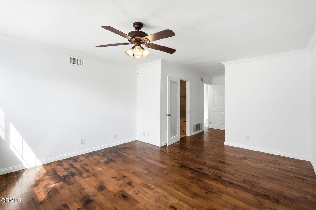 2082 Belgrave Court Simi Valley, CA 93063 - Photo 30 of 56 a view of an empty room with wooden floor and a ceiling fan