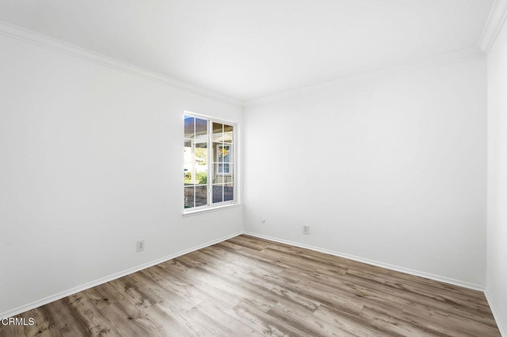 2082 Belgrave Court Simi Valley, CA 93063 - Photo 38 of 56 an empty room with wooden floor and windows