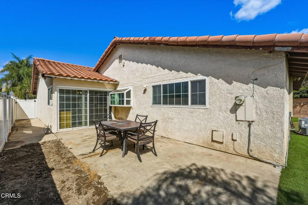 2082 Belgrave Court Simi Valley, CA 93063 - Photo 42 of 56 a patio with table and chairs and potted plants