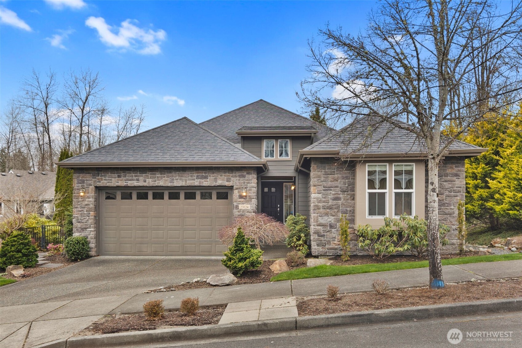 23124 Northeast Devon Way Redmond, WA 98053 - Photo 1 of 34 a front view of a house with a yard and garage