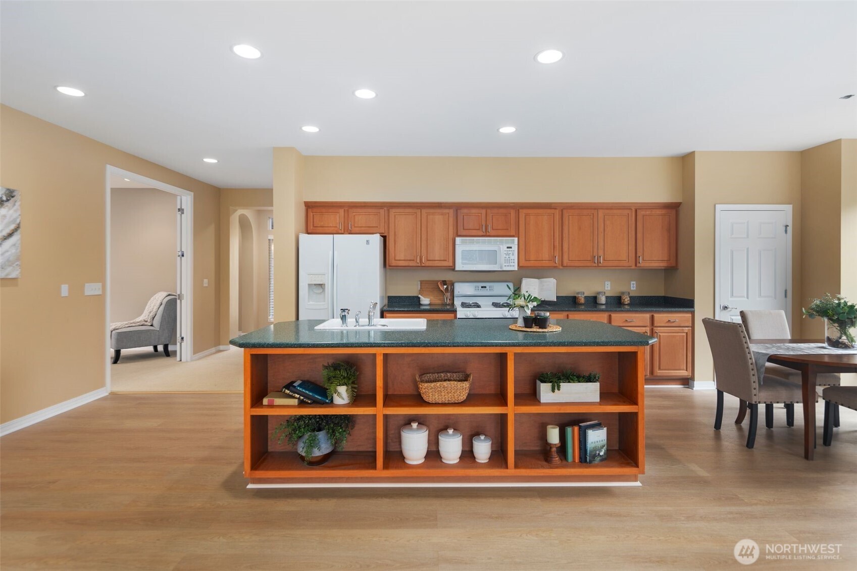 23124 Northeast Devon Way Redmond, WA 98053 - Photo 22 of 34 a kitchen with stainless steel appliances a table and chairs