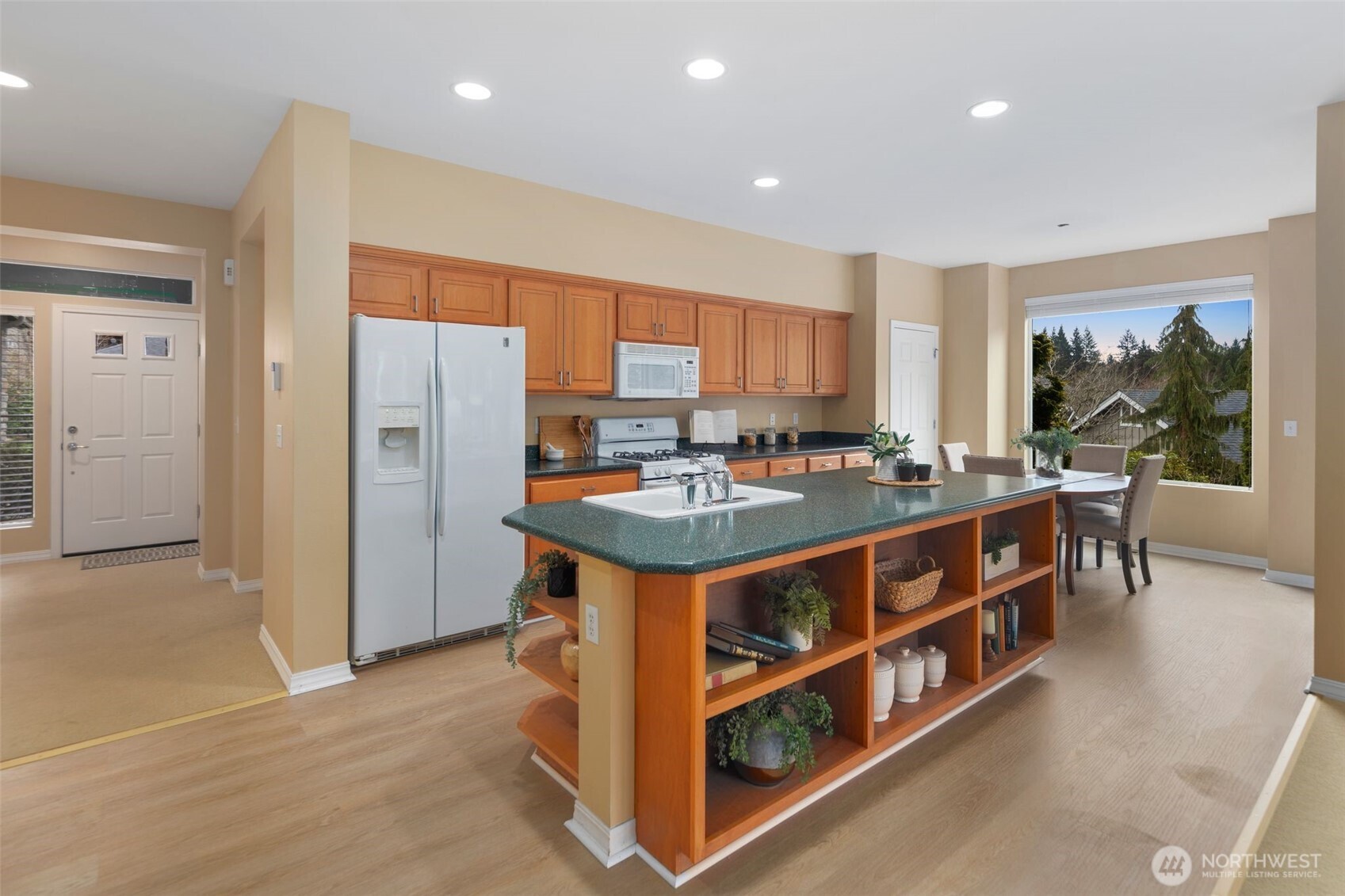 23124 Northeast Devon Way Redmond, WA 98053 - Photo 23 of 34 a kitchen with stainless steel appliances granite countertop a stove a refrigerator a sink a dining table and chairs