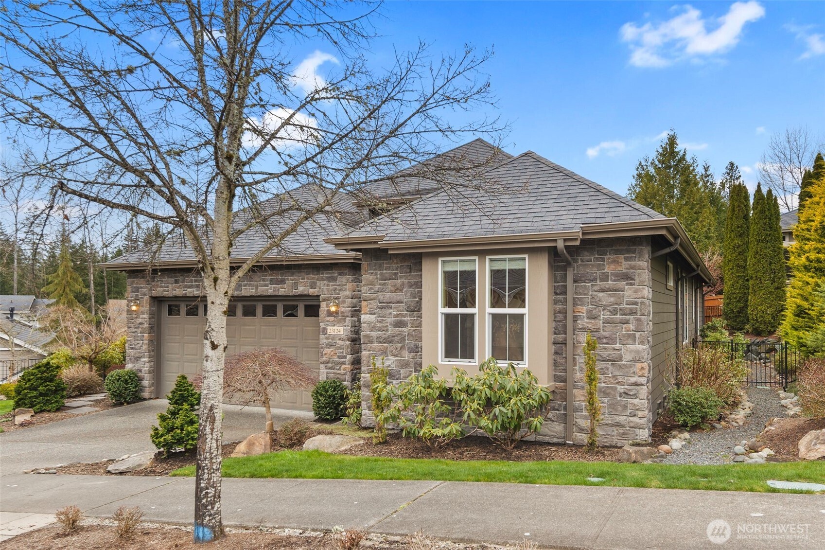 23124 Northeast Devon Way Redmond, WA 98053 - Photo 3 of 34 a front view of a house with garden