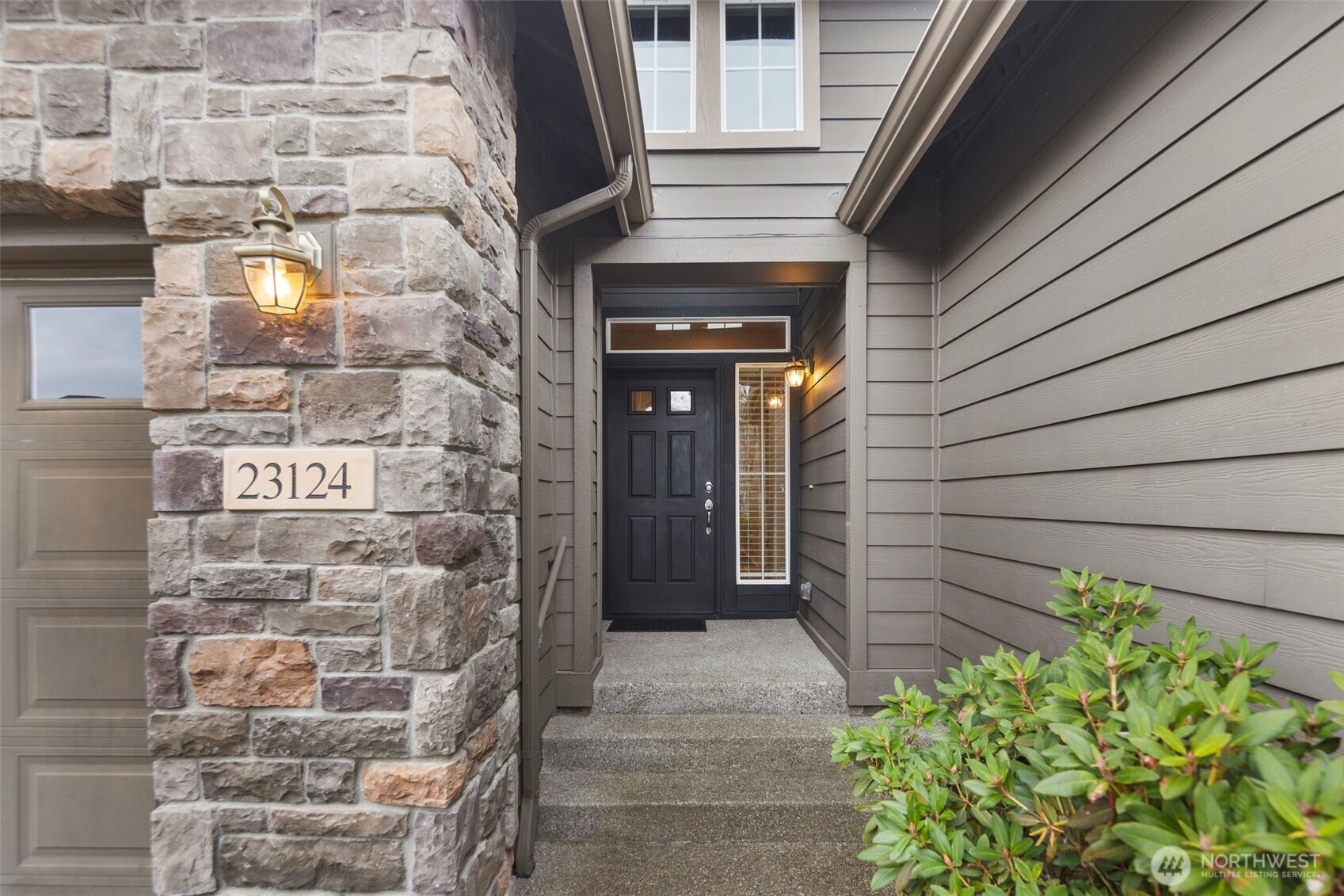 23124 Northeast Devon Way Redmond, WA 98053 - Photo 4 of 34 a view of front door of house with potted plants