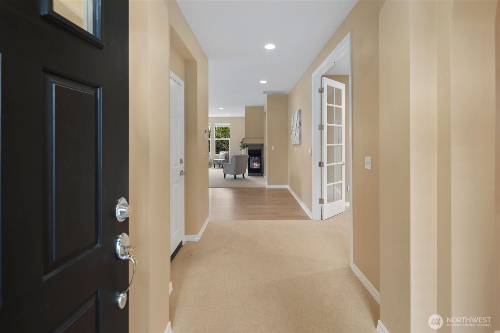 23124 Northeast Devon Way Redmond, WA 98053 - Photo 5 of 34 a view of a hallway with wooden floor and a living room