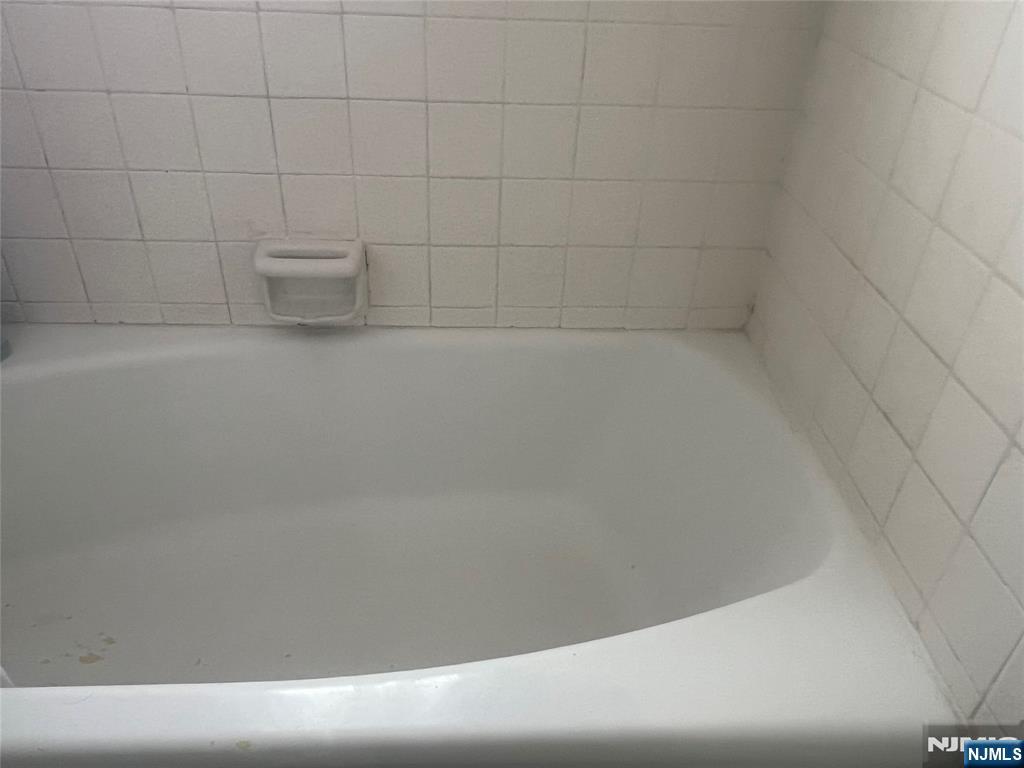 52 Anderson Avenue, Unit 2 Fairview, NJ 07022 - Photo 1 of 3 a bathroom with a bathtub