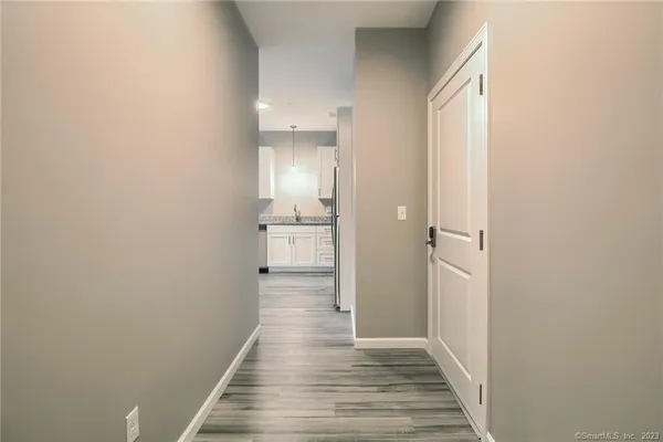 a view of a hallway with wooden floor