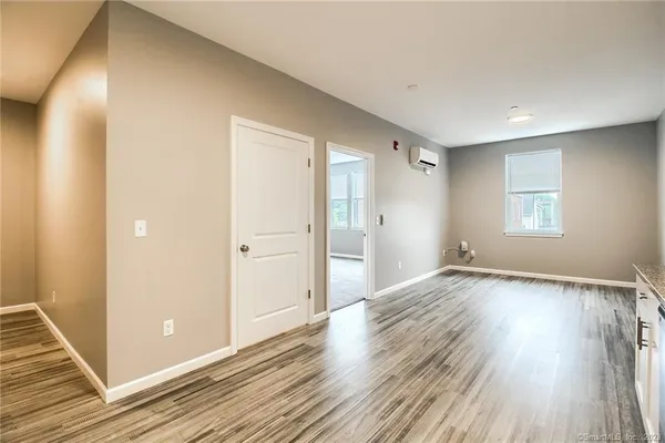 a view of a livingroom with wooden floor and window