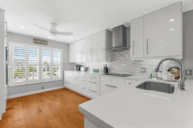 a living room with furniture and view of kitchen