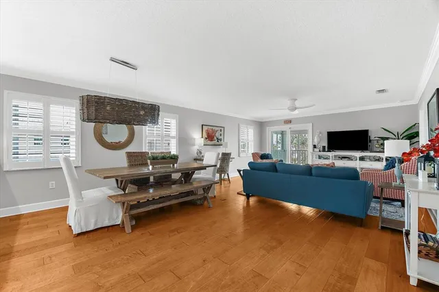 a kitchen with stainless steel appliances granite countertop a stove a sink dishwasher and a refrigerator with wooden floor