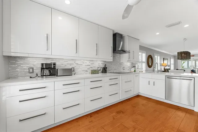 a living room with furniture kitchen view and a flat screen tv