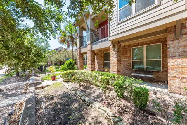a view of a house with backyard porch and sitting area