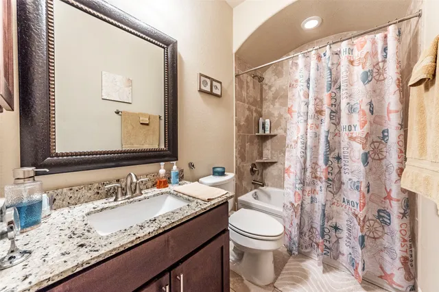 a living room with furniture a fireplace and a chandelier