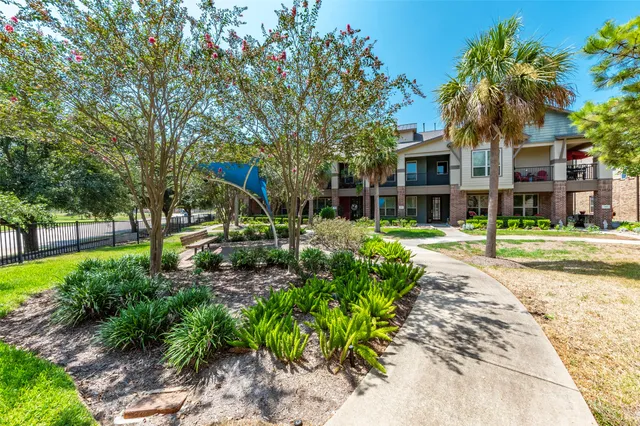 a front view of a house with a yard and a garage