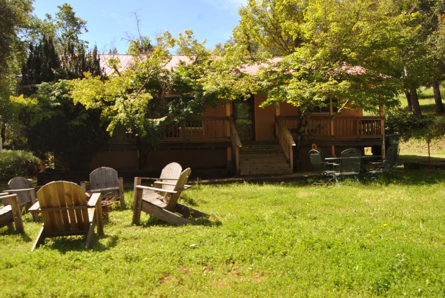 3640 Omo Ranch Road Somerset, CA 95684 - Photo 2 of 57 a backyard of a house with table and chairs