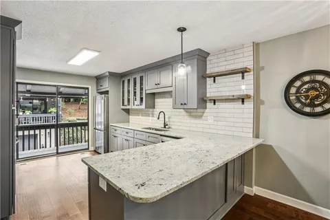 a kitchen with a sink a stove and cabinets
