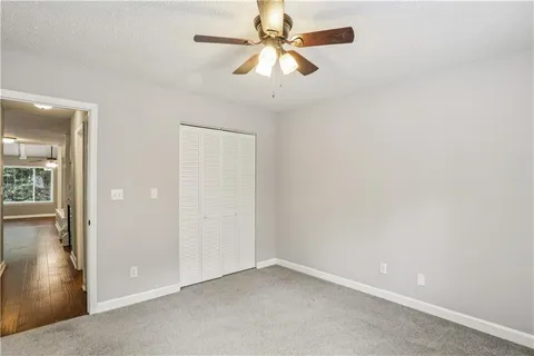an empty room with fan and entrance