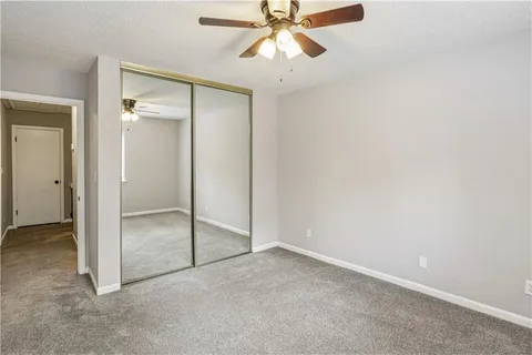 an empty room with fan and entrance