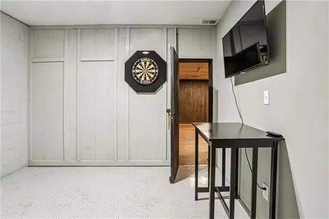 a view of empty room with wooden floor