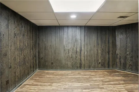 a view of a white building among the street with palm trees