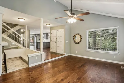 a view of a hallway with windows and wooden floor
