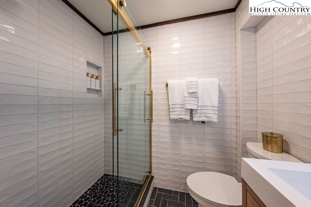 102 Ridge Drive Linville, NC 28646 - Photo 42 of 48 a bathroom with a toilet a sink and shower