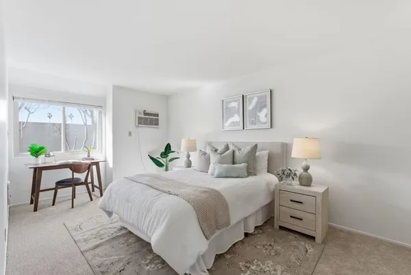a bedroom with bed and a window