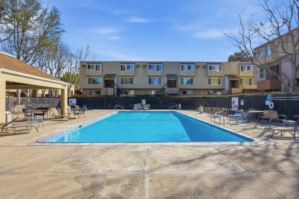 a view of a house with swimming pool and sitting area