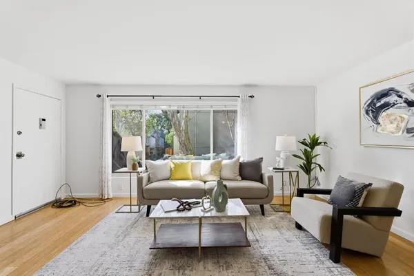 a living room with furniture and a large window