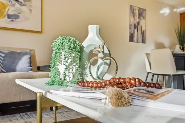 a view of a dining room with furniture and a chandelier