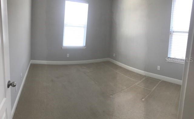 8549 Pinter Street Orlando, FL 32827 - Photo 12 of 25 an empty room with a window